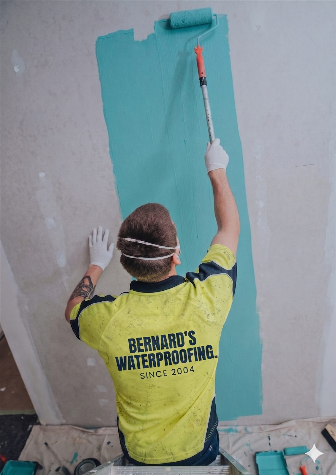 Bernard Waterproofing team member applying waterproofing membrane to an external wall on a Sydney property