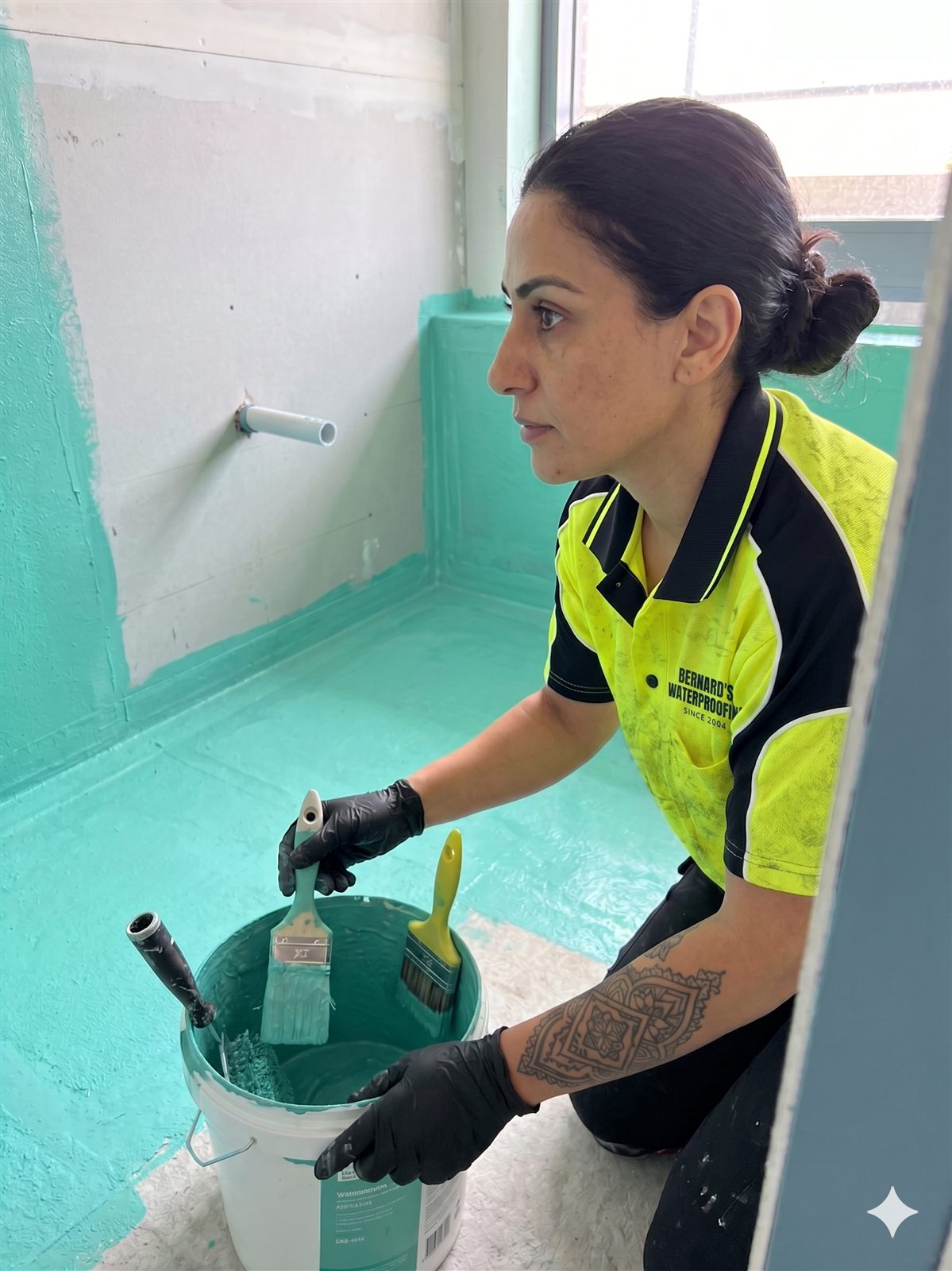 Bernard Waterproofing team member waterproofing a laundry wet area