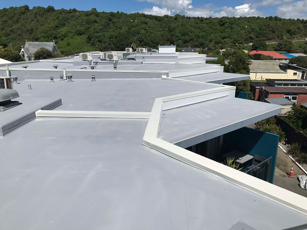 Aerial view of a large commercial flat roof with professionally applied waterproofing membrane